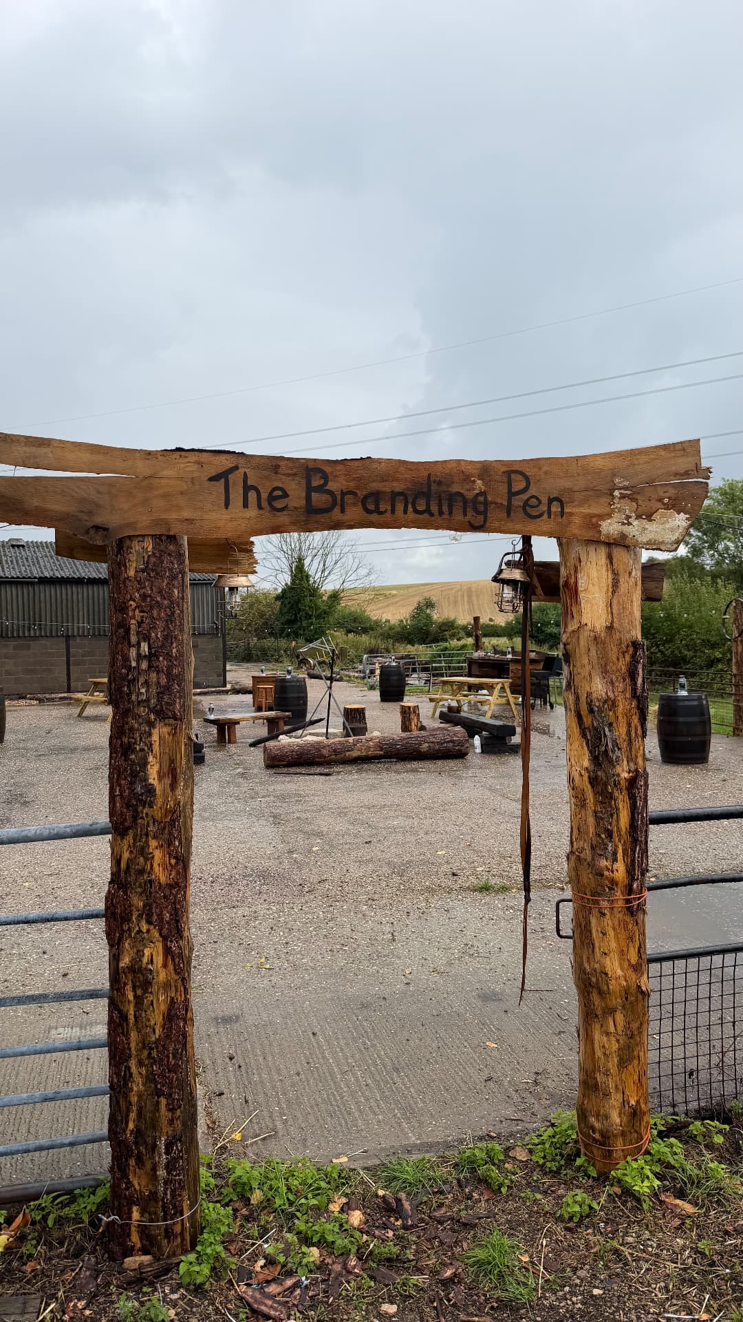 Hand-painted wooden entrance arch with The Branding Pen sign